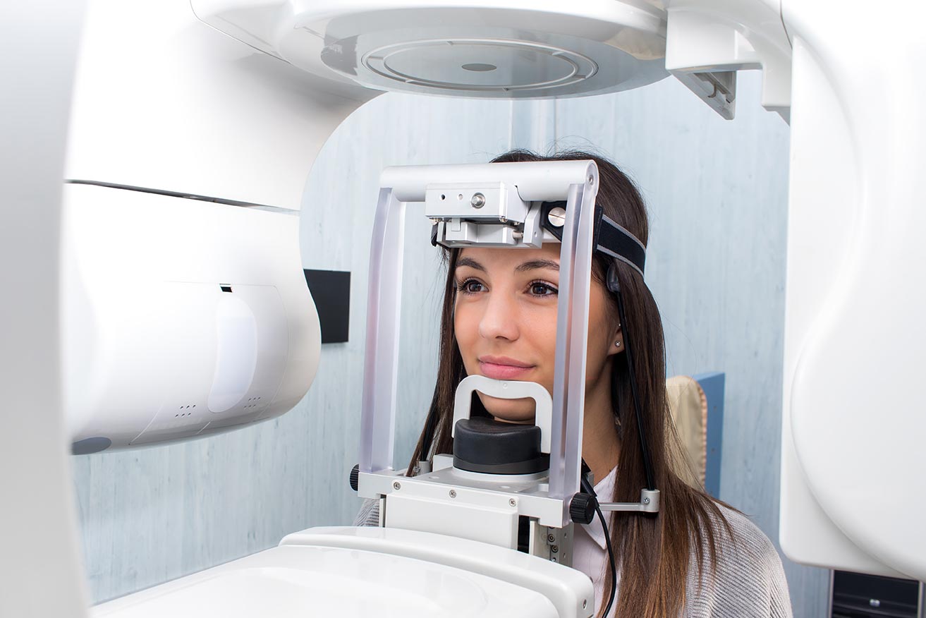 A dental patient gets her teeth imaged at the dentist office.